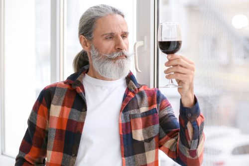 Senior man drinking wine ageing in place