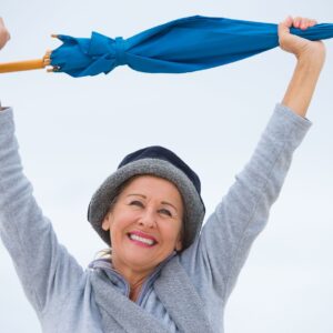 A woman holding up an umbrella in the air.