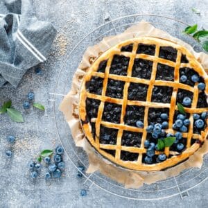 A pie with blueberries on top of it.