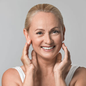 A woman with her hands on the face