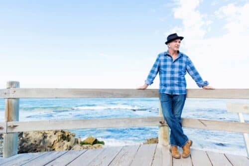 A man standing on the edge of a pier.